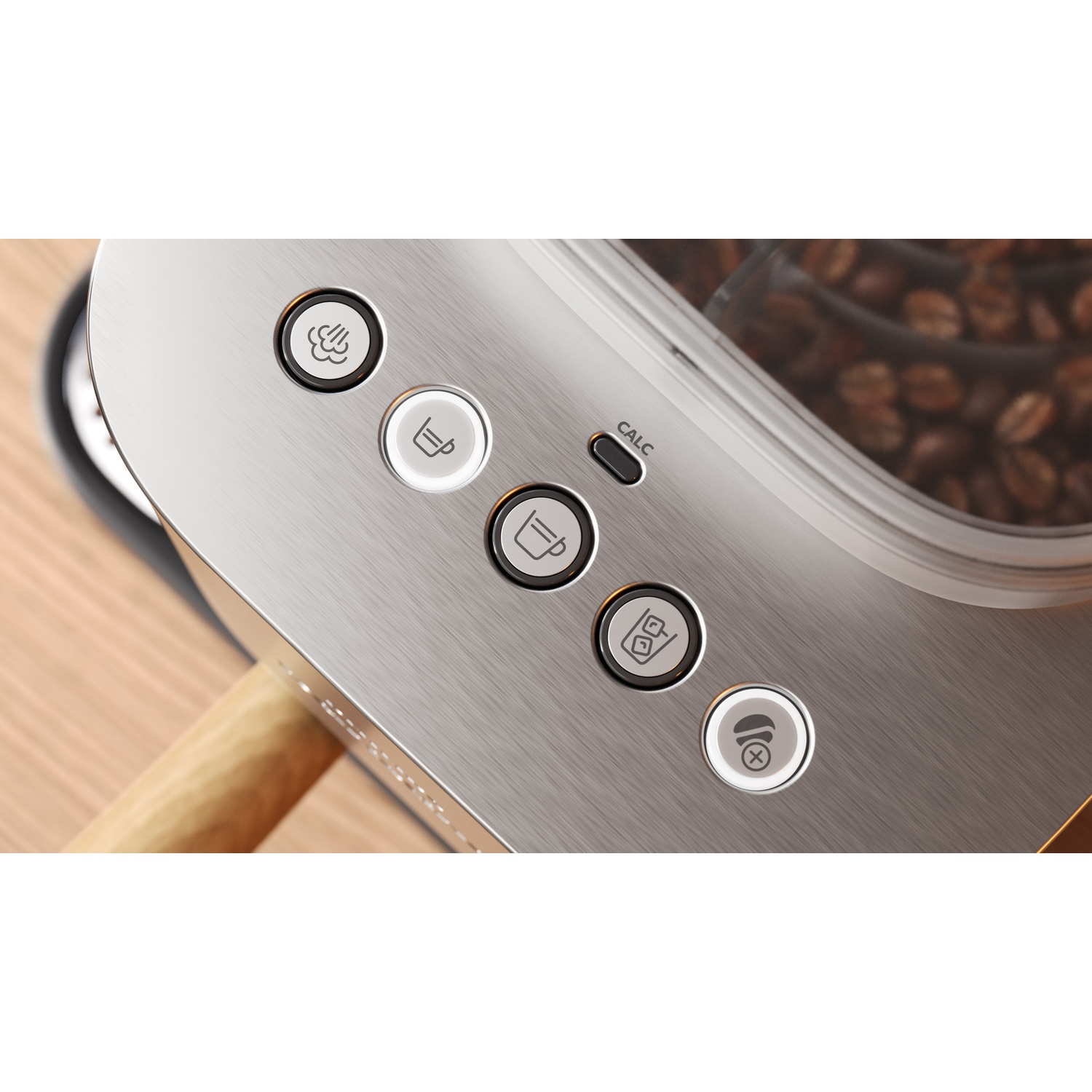Close-up of buttons on a silver coffee machine, with coffee beans in the background.