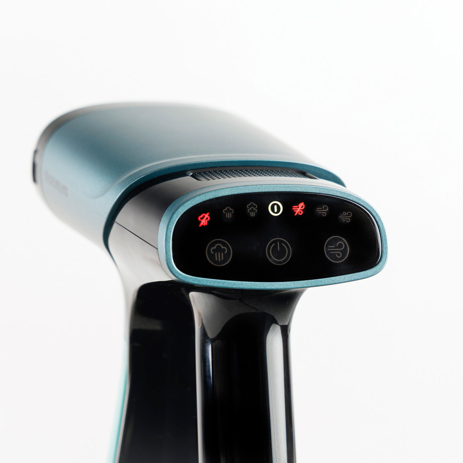 Vaporizador de tela azul verdoso y negro con iconos iluminados de vapor y ventilador.
