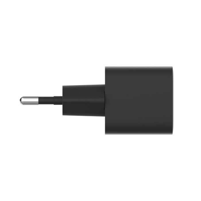Un adaptador de corriente negro con un pin metálico.
