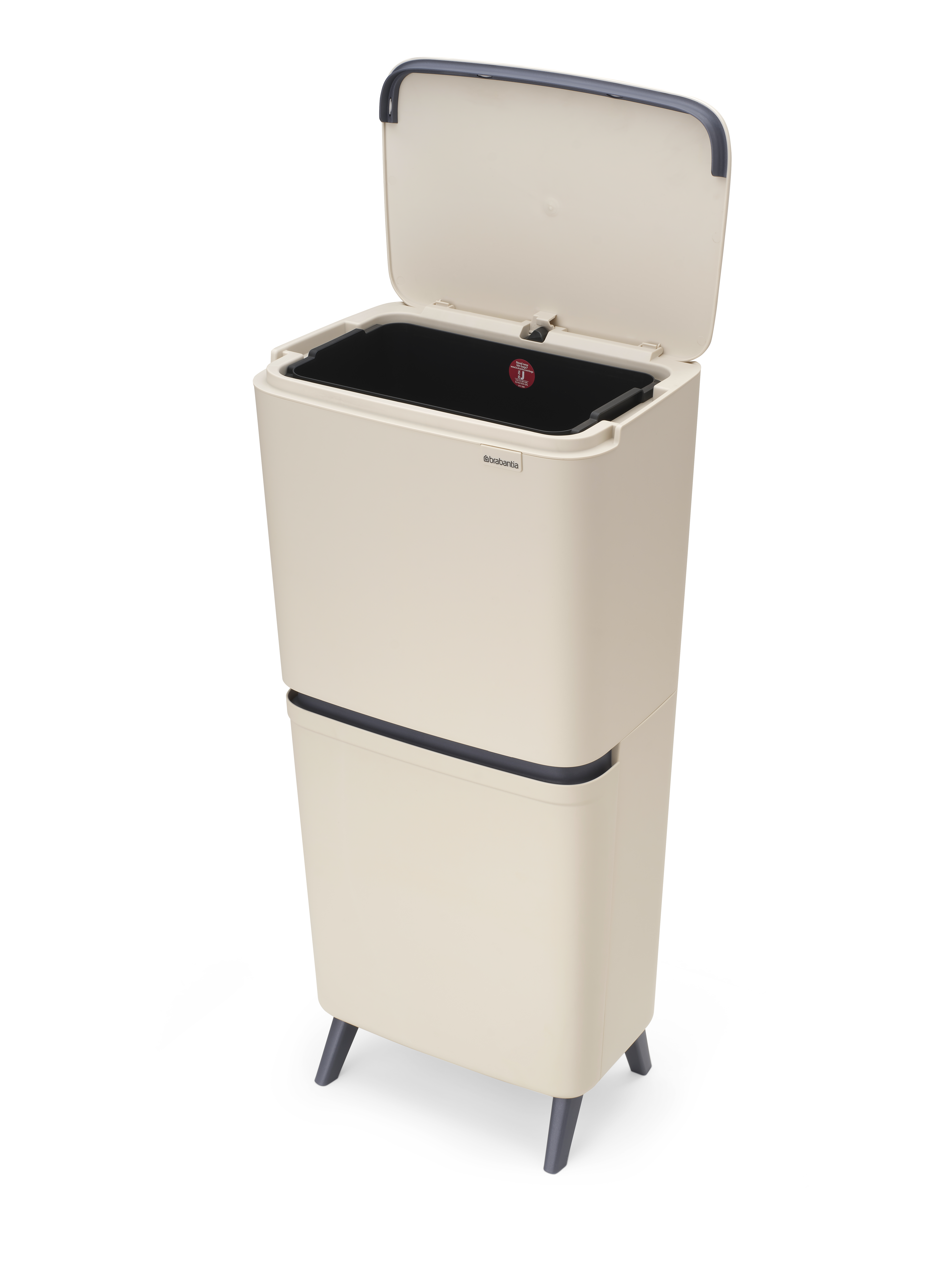 Beige Biomüll-Trennbehälter mit schwarzem Einsatz und offenem Deckel auf vier Beinen.