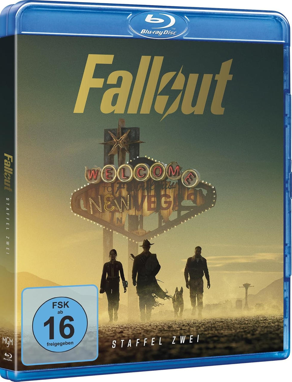 Blu-ray Cover: Drei Personen und ein Hund gehen auf eine leuchtende "Welcome to New Vegas" Reklame zu.