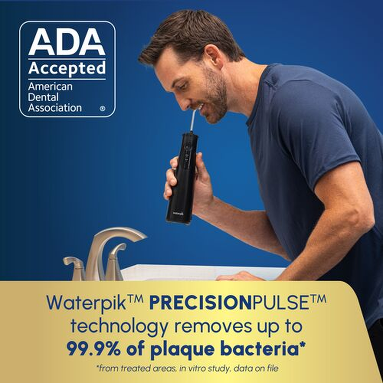 Man uses a water flosser at a sink with an ADA Accepted seal.