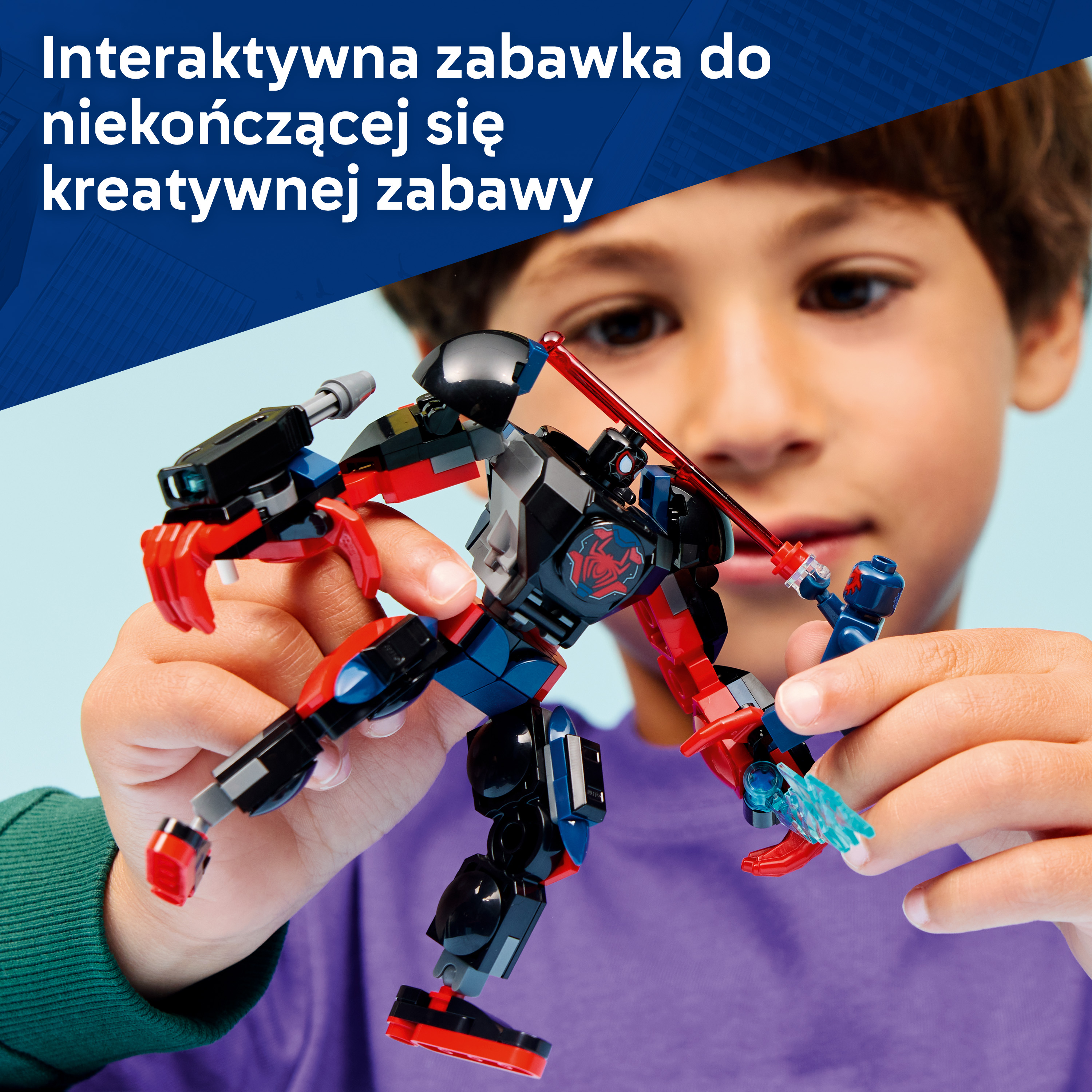 Chłopiec trzyma czerwoną i czarną figurkę robota z niebieskimi akcentami.