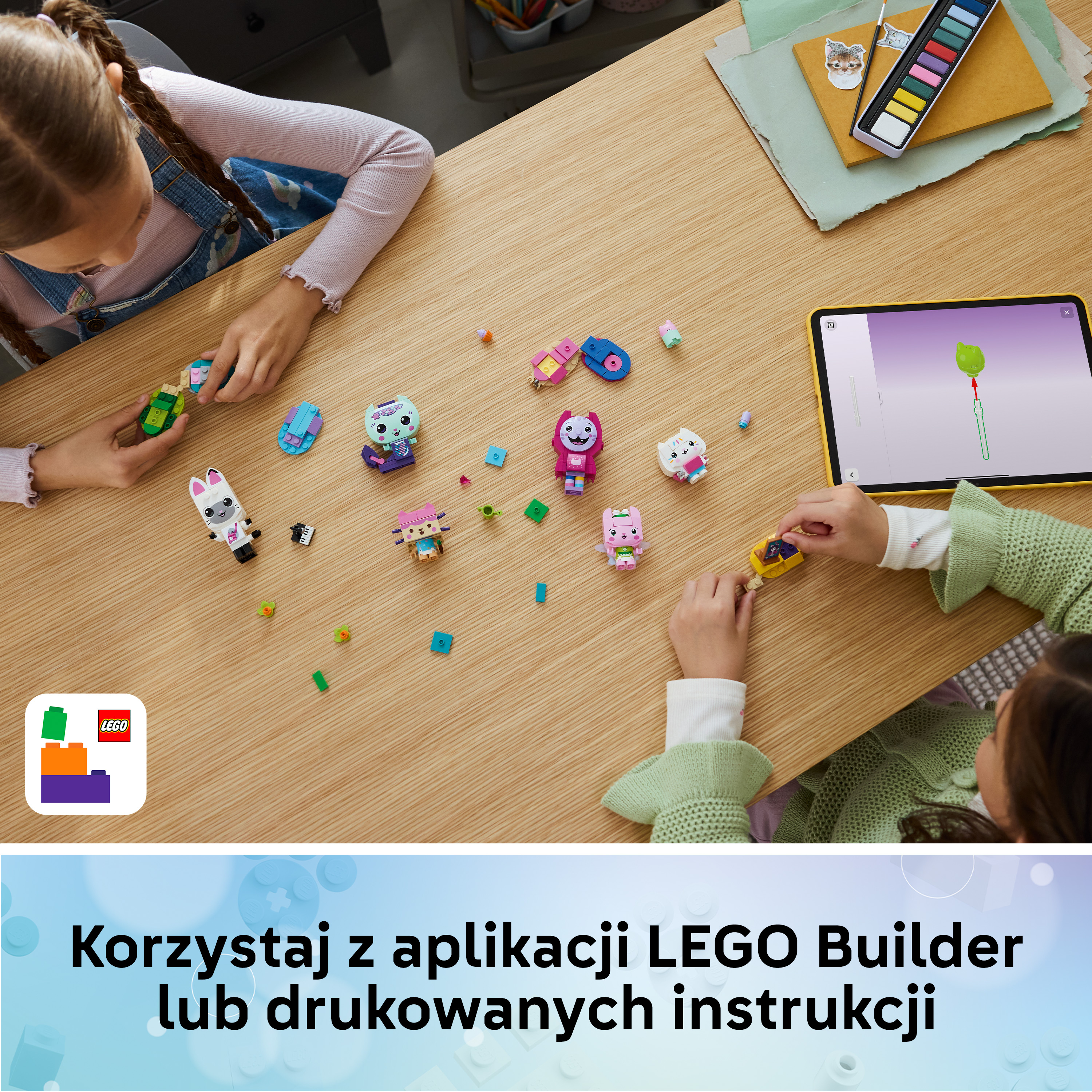 Dzieci budują z klocków Lego i oglądają instrukcje na tablecie.