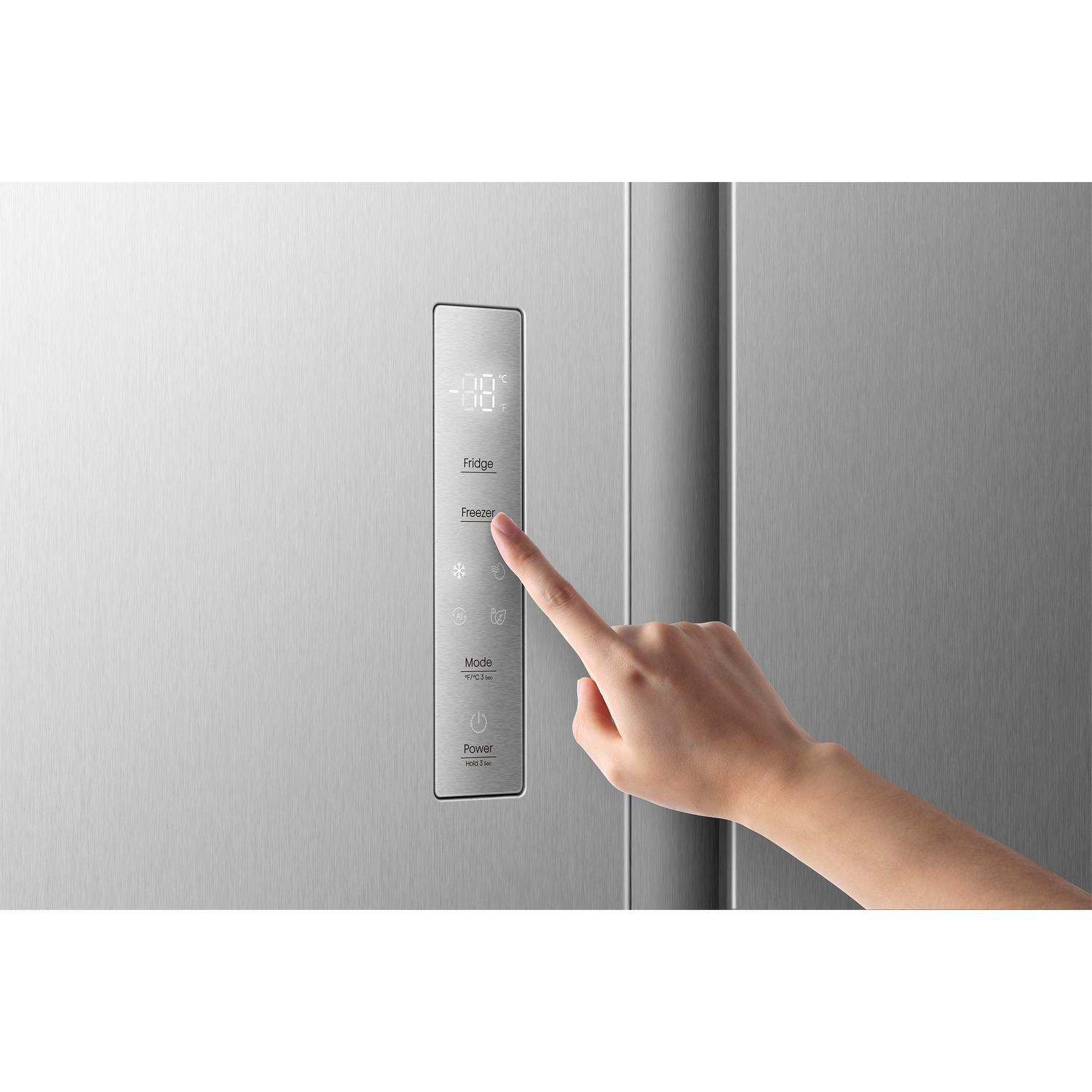 A hand touches a refrigerator control panel displaying temperatures.
