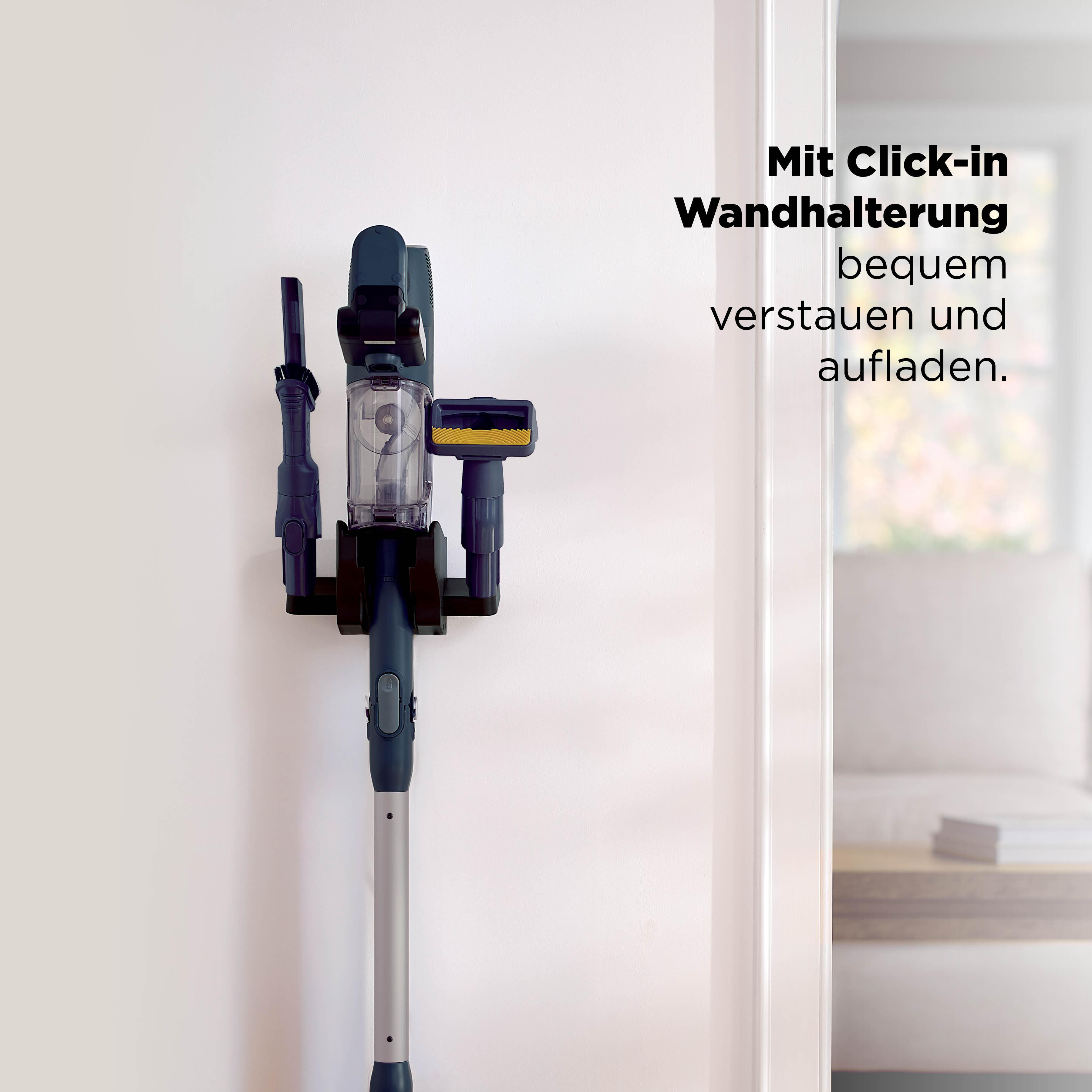 Ein dunkelgrauer Handstaubsauger mit Zubehör ist an einer weißen Wandhalterung befestigt.