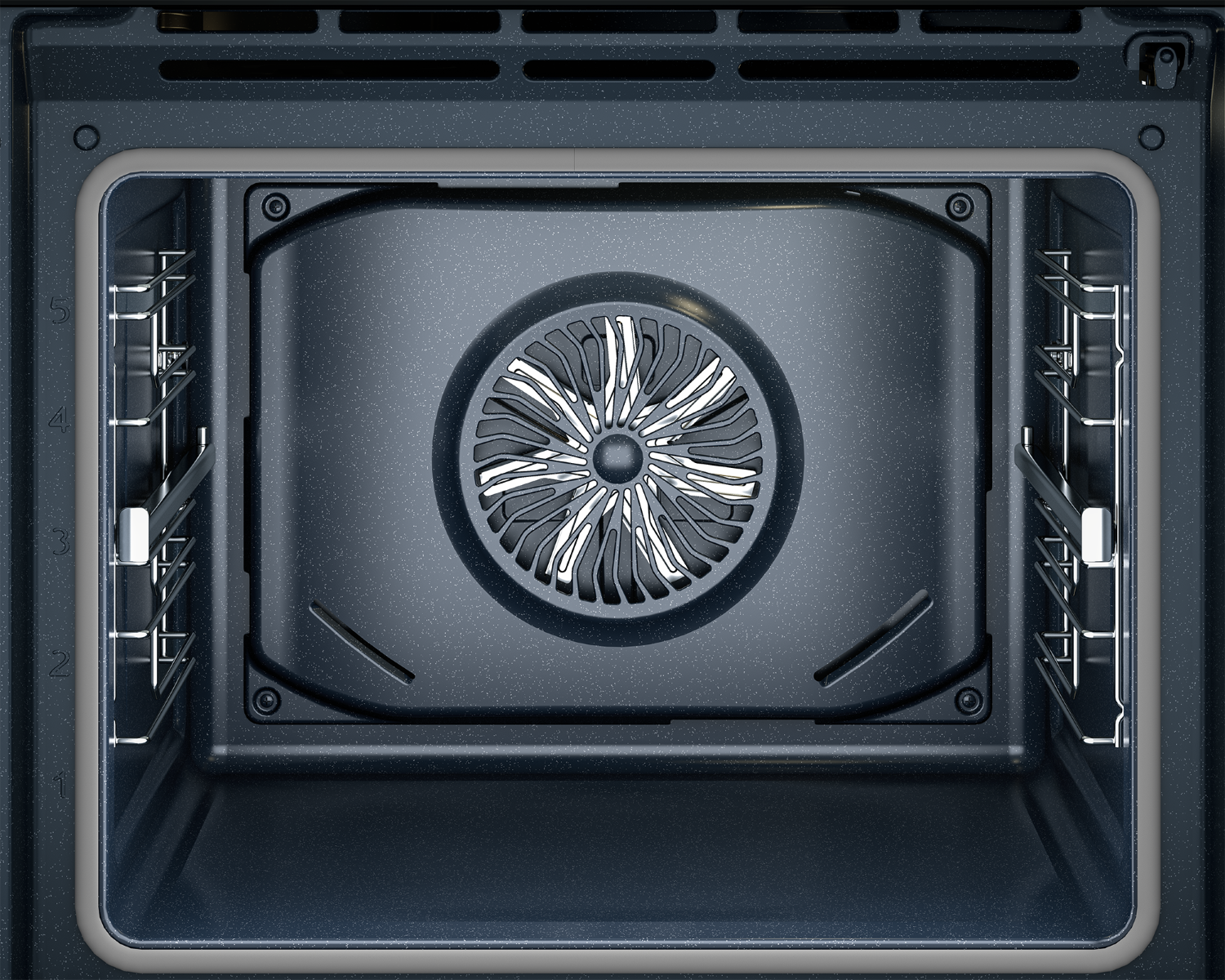Vista interior de un horno oscuro con ventilador y guías.