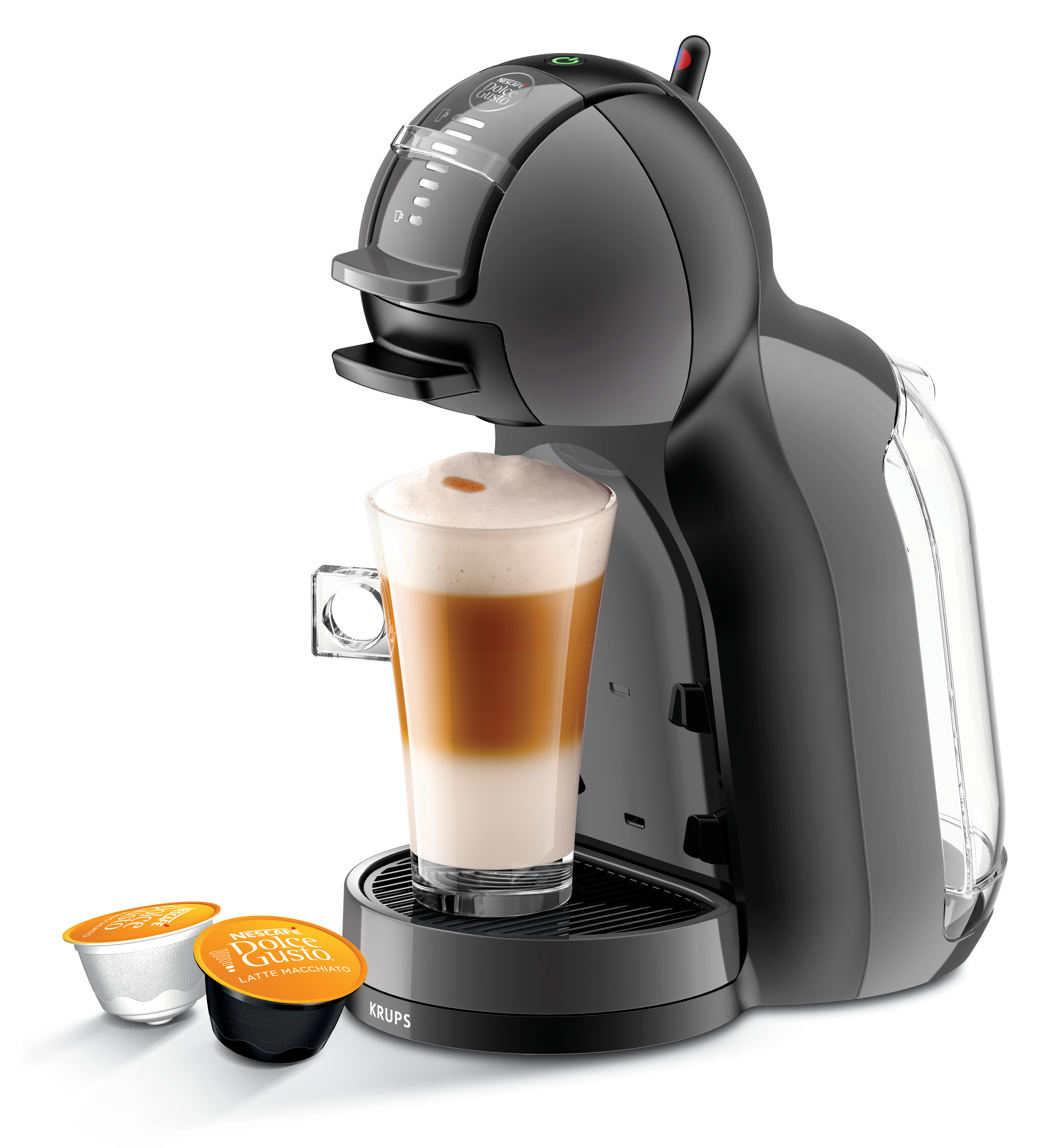 Fekete kávéfőző latte macchiato-val és két kávékapszulával mellette.