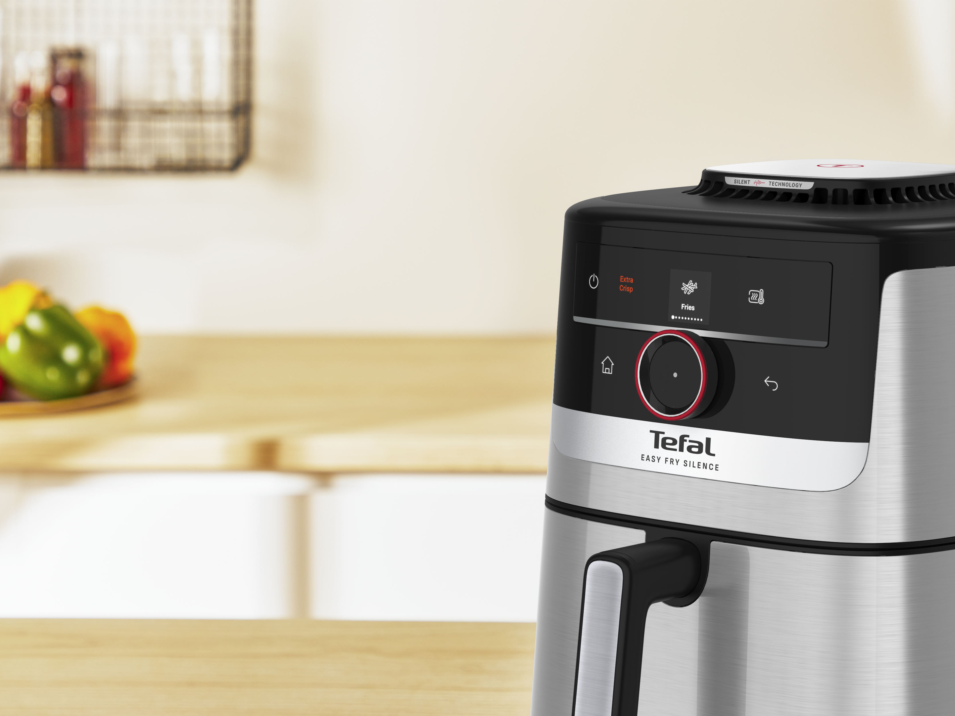 Ezüst Tefal légkeveréses fritőz digitális kijelzővel és fogantyúval.