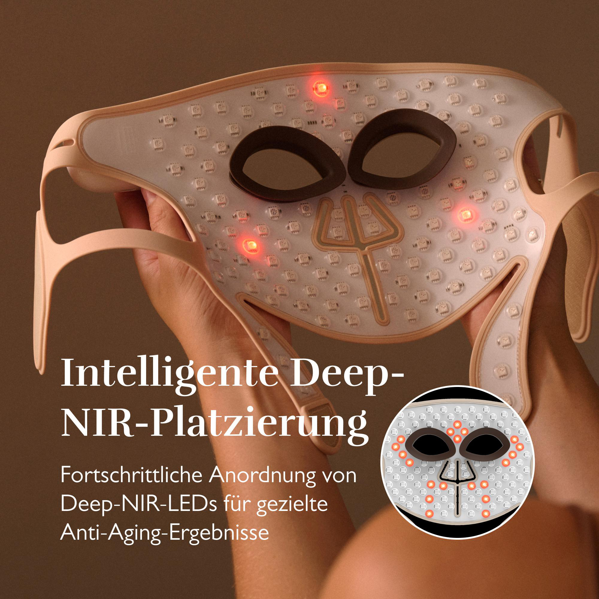 Hände halten eine Gesichtsmaske mit roten LEDs und Augenöffnungen.