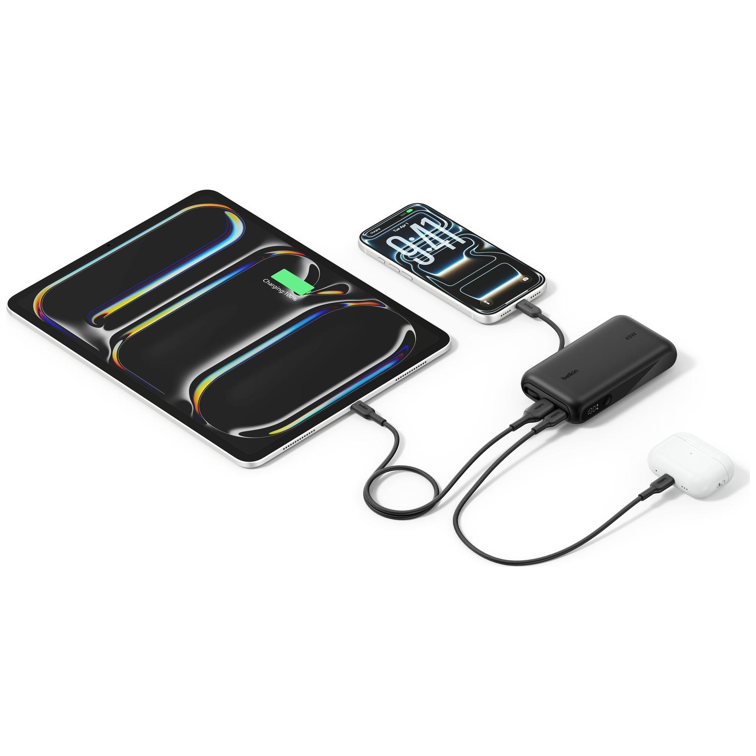 A black Belkin power bank charges a phone, tablet, and earbuds. 100% charged.