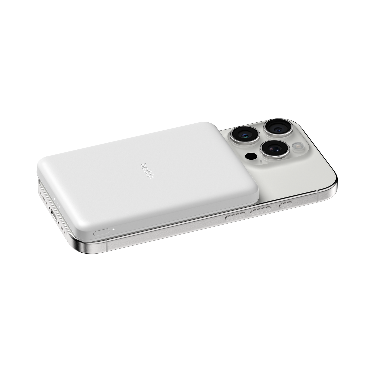 A white Belkin MagSafe charger is attached to the back of a silver iPhone 13 Pro.