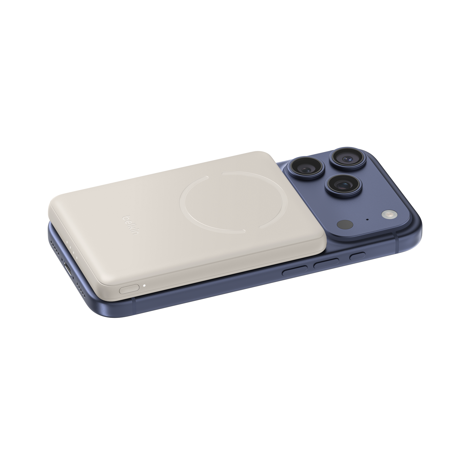 A cream-colored power bank rests on a blue smartphone.