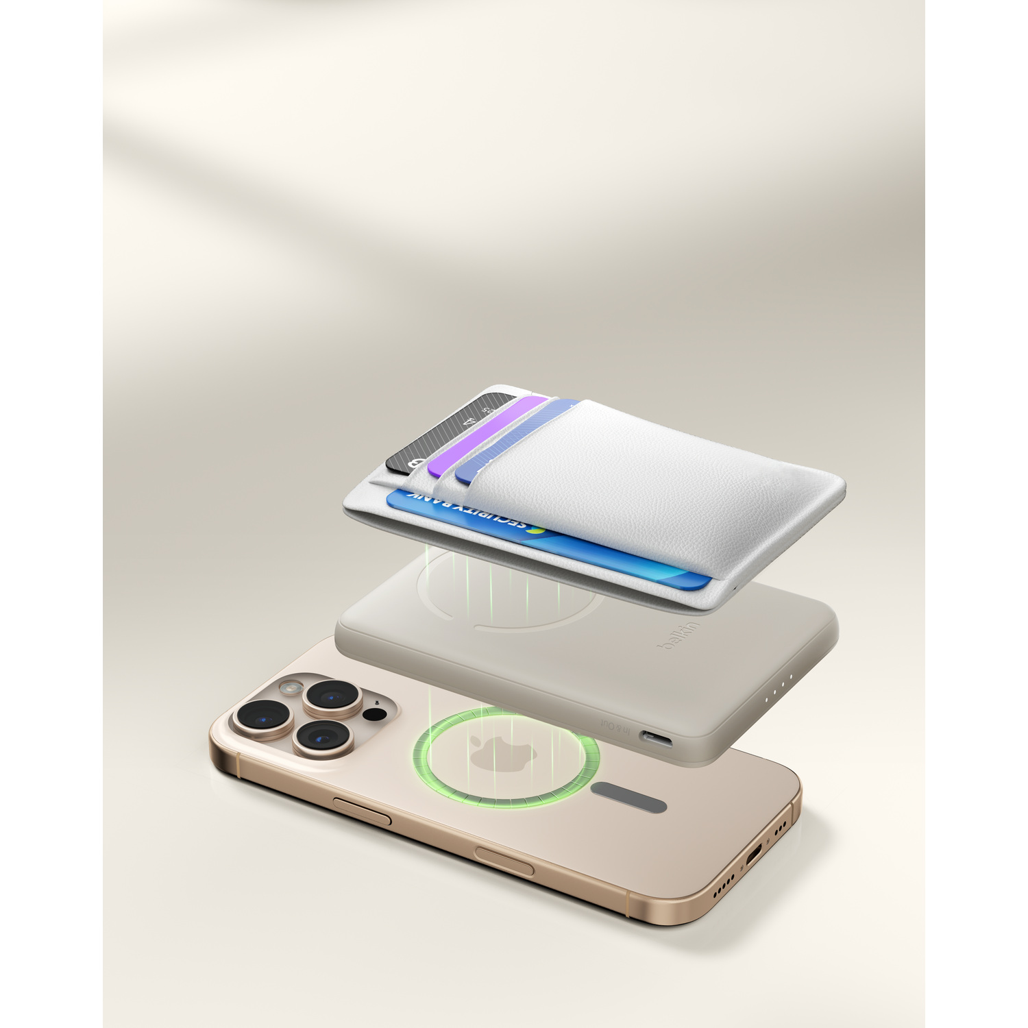 A gold iPhone with a white card holder and charger on a plain background.