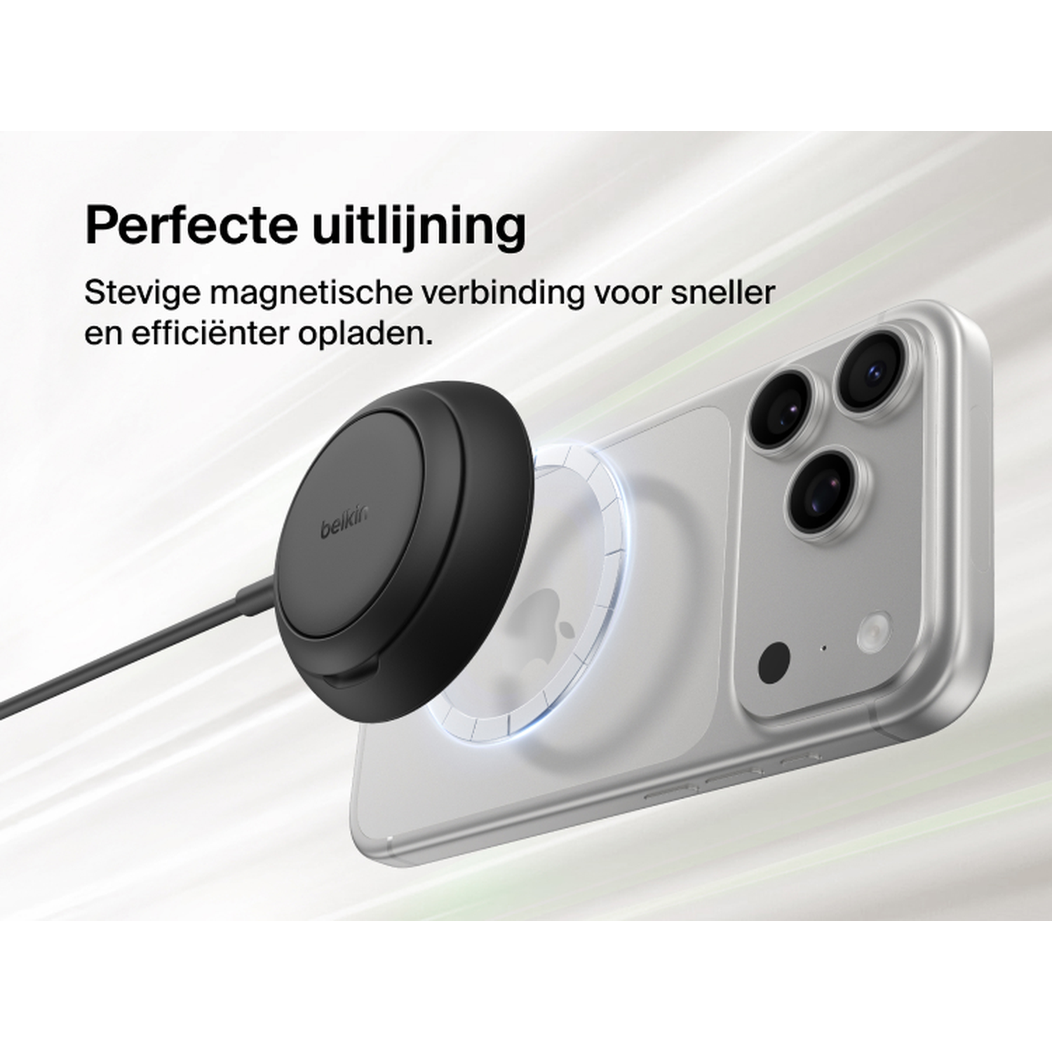 Black Belkin charger magnetically attached to a silver iPhone.