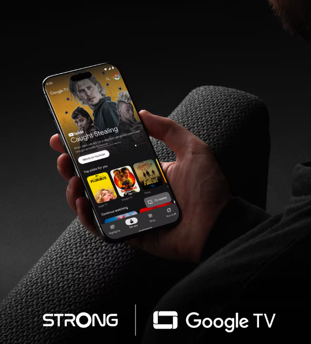 Mann hält Smartphone mit Google TV-App, zeigt Film-Vorschläge.
