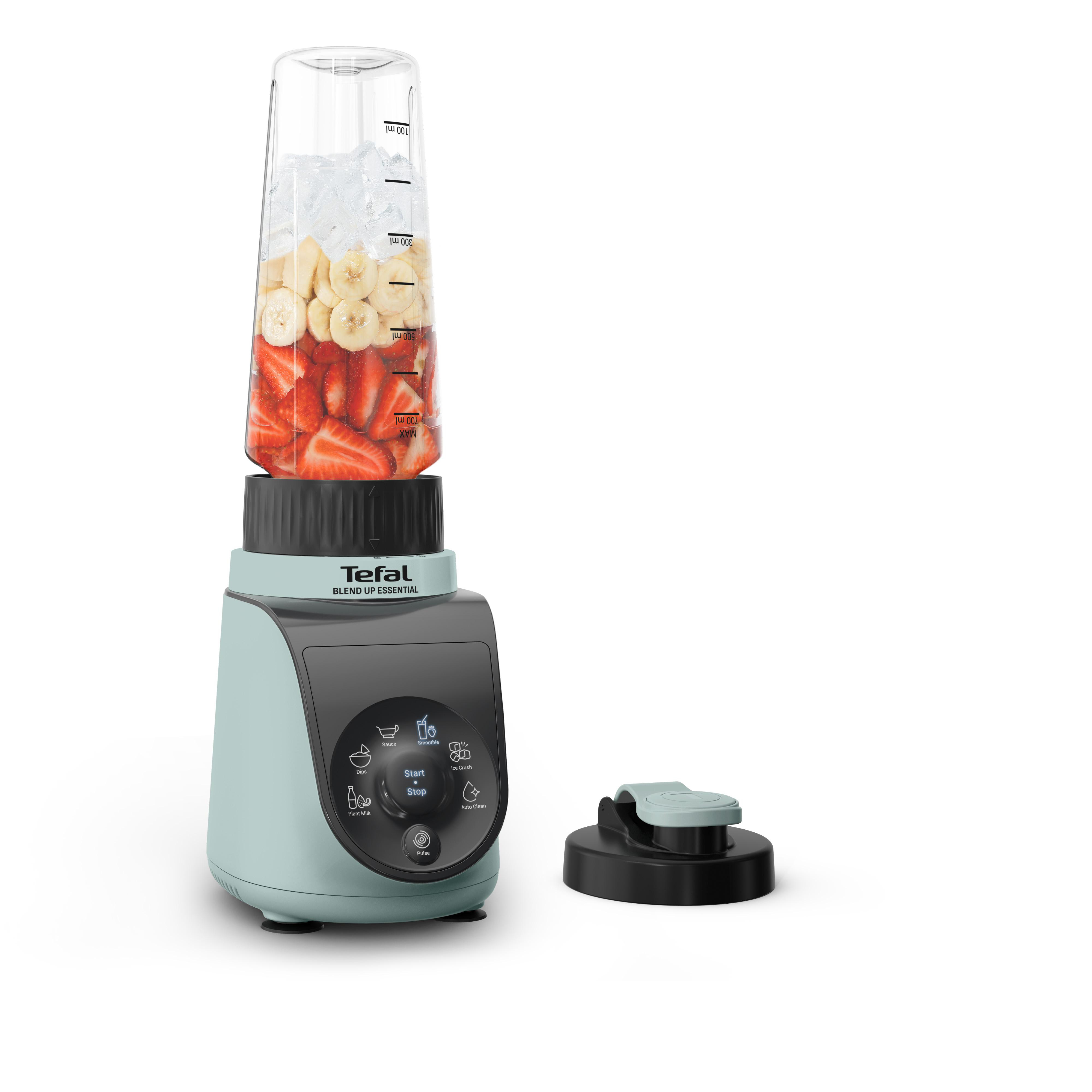 Ein mintgrüner Mixer mit Früchten und Eis im Behälter.