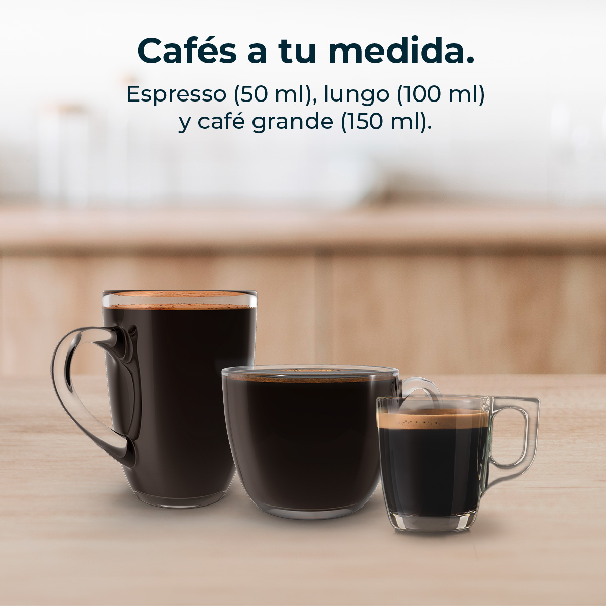 Tres tazas de café de diferentes tamaños sobre una mesa de madera.