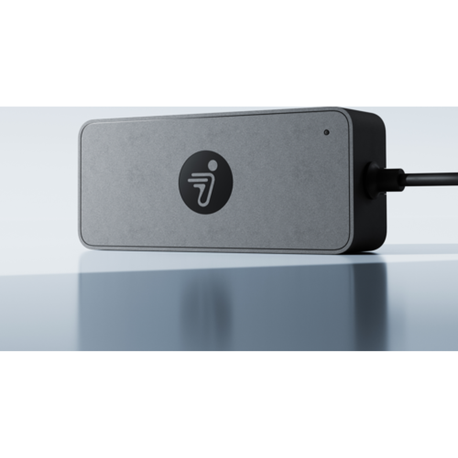 Grijs elektronisch apparaat met zwart logo en kabelaansluiting.