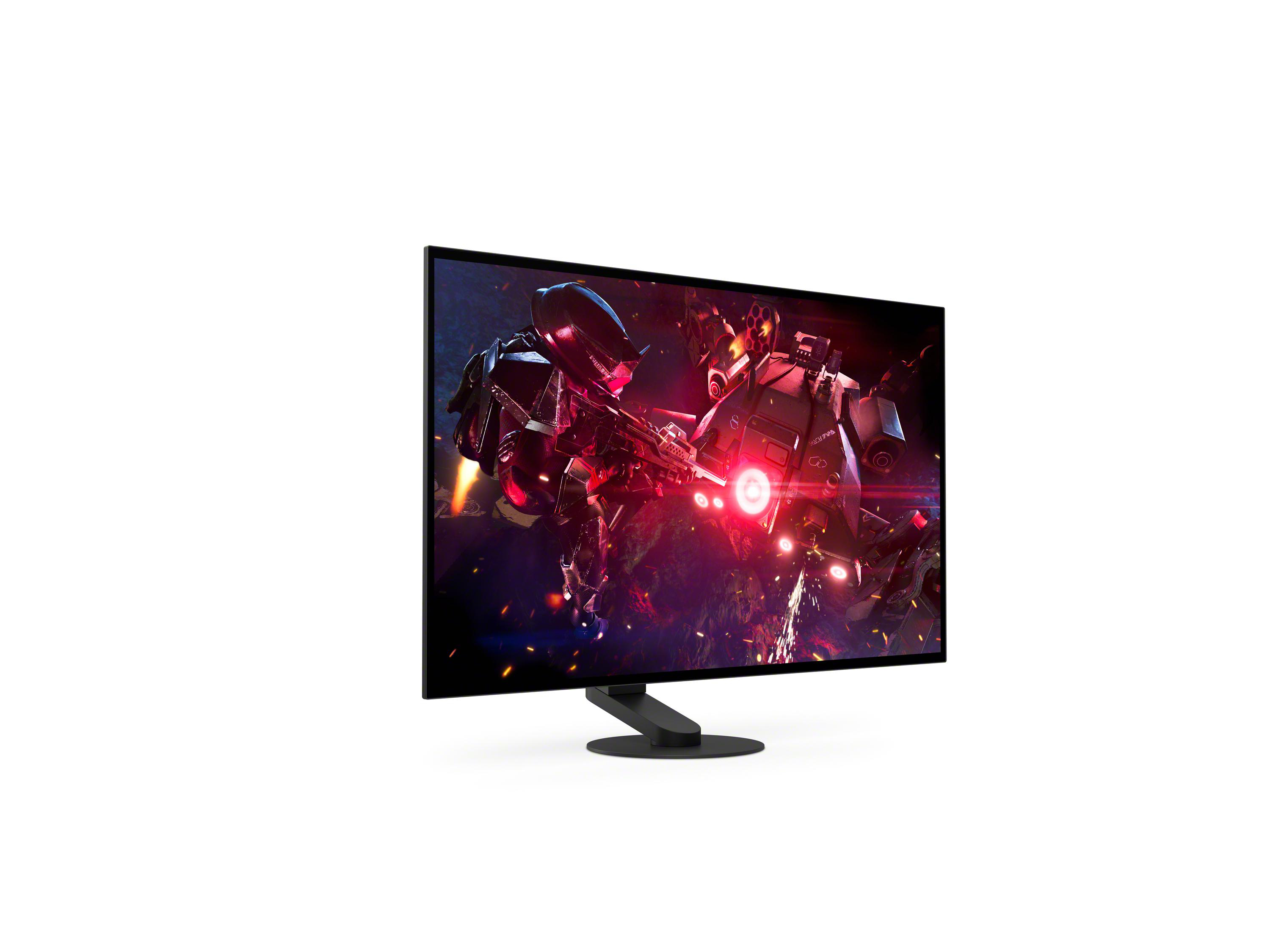 Ein Monitor zeigt ein Spiel mit Robotern und Explosionen.