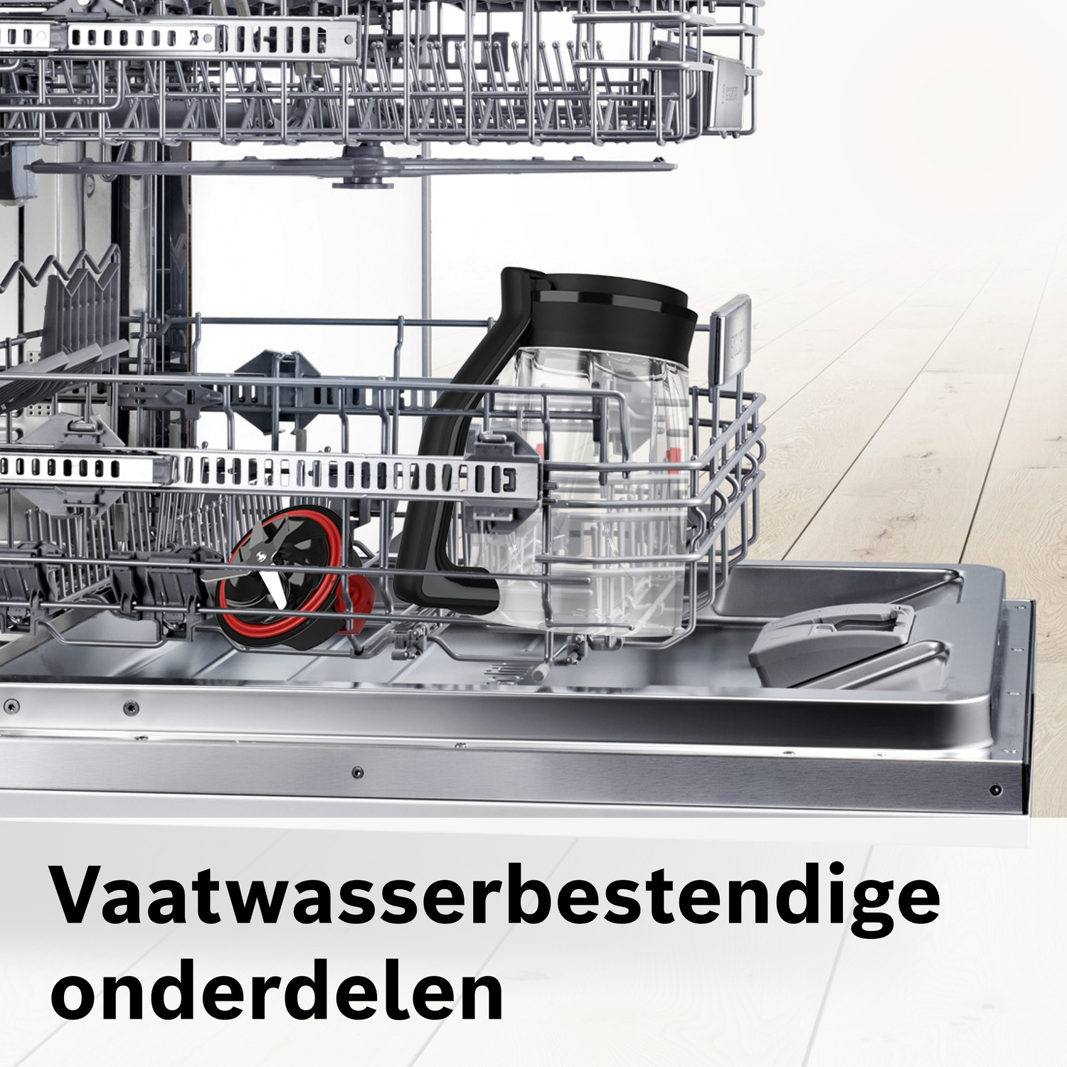 Dishwasher interior with open rack holding a pitcher and a red-black part.