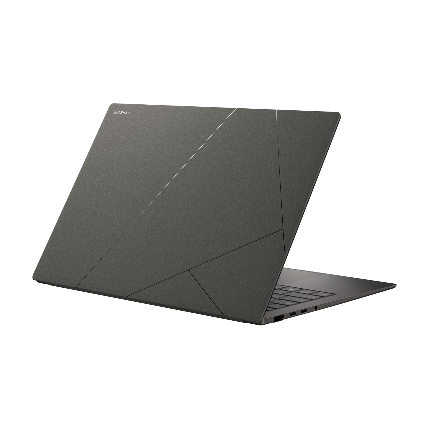 Un laptop grigio scuro chiuso con logo ASUS Zenbook e motivo geometrico.