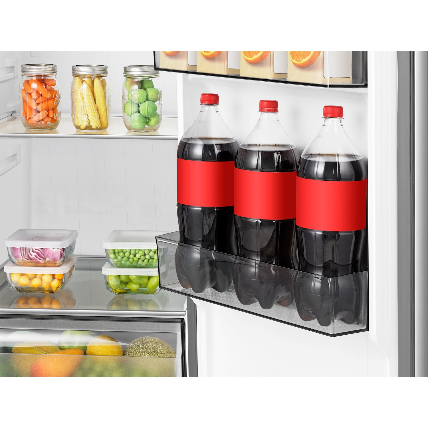 Inside a refrigerator: jars of carrots, corn, peas, and bottles of soda.