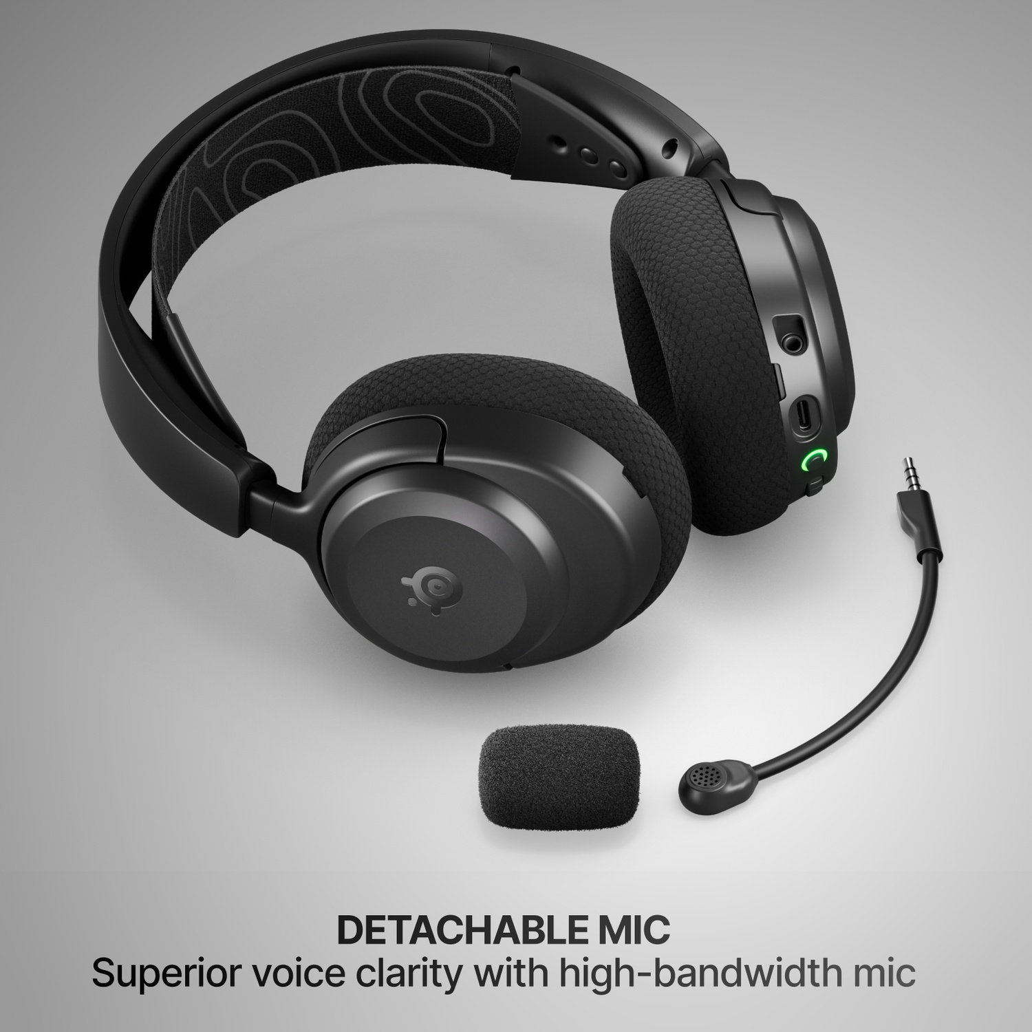 Casque noir avec microphone détachable et bandeau à motifs.