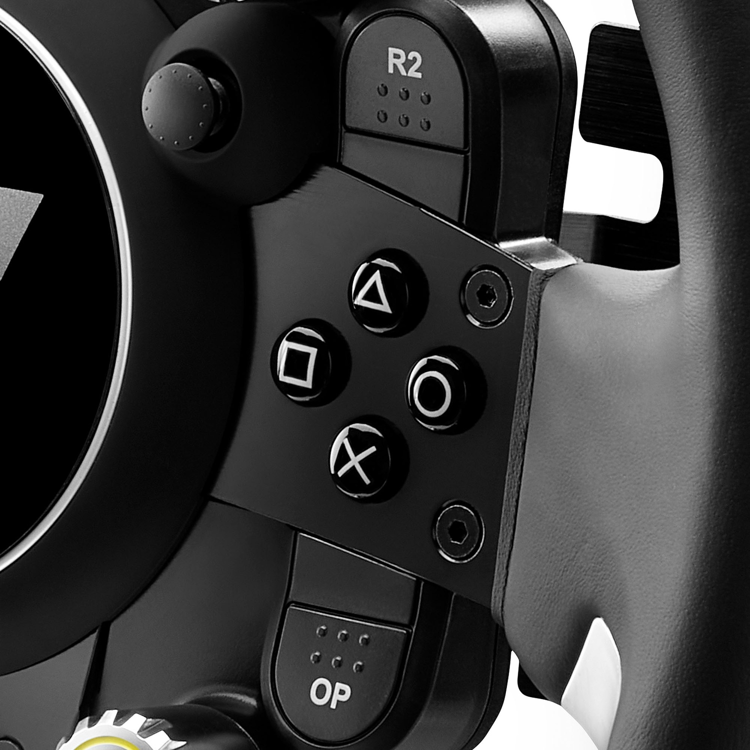Close up of a black gaming steering wheel with game symbols and buttons.
