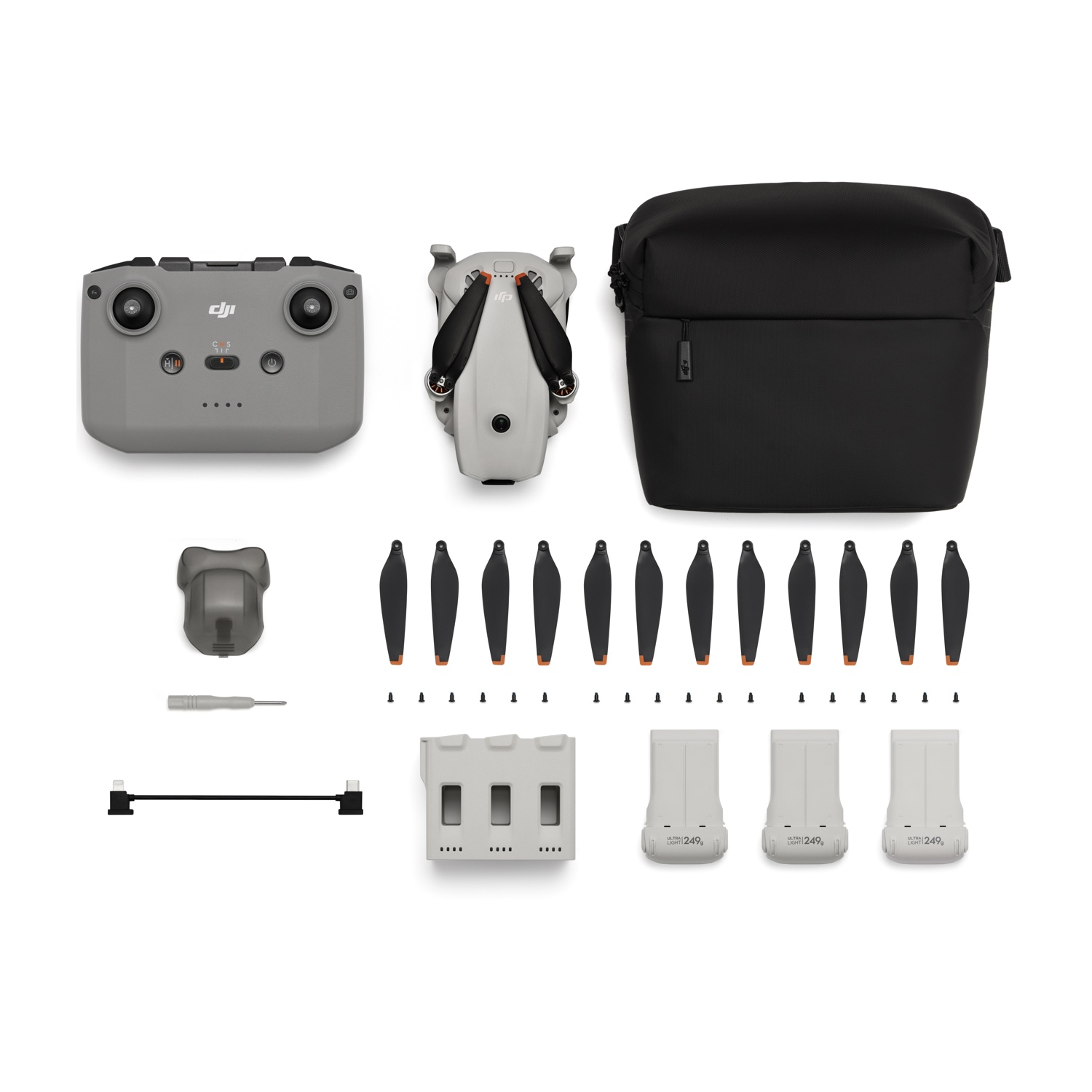 Drone con accessori: telecomando, borsa, eliche, batterie, cacciavite.