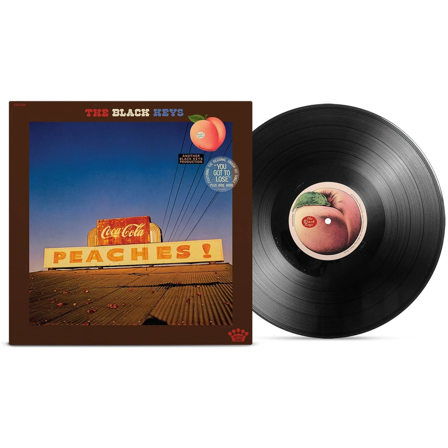 Pochette d'album The Black Keys avec panneau Coca-Cola et texte "PEACHES !", à côté d'un vinyle.