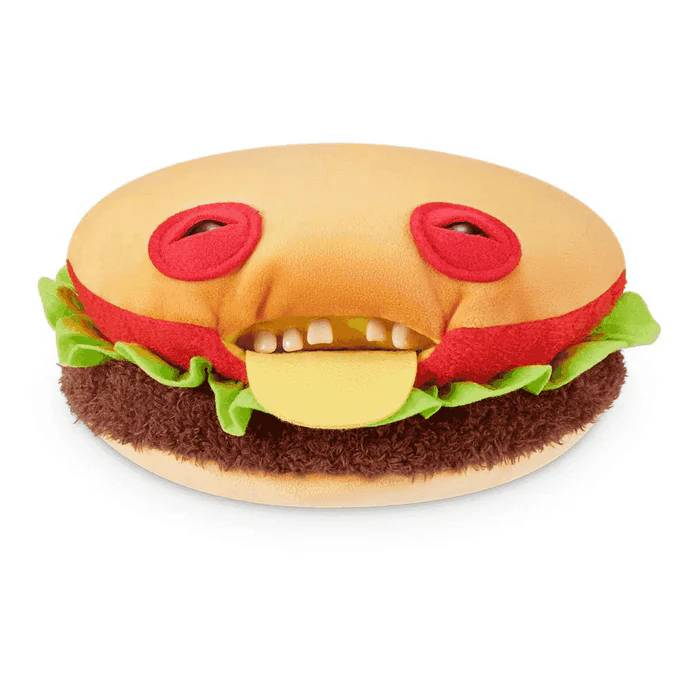 Una hamburguesa de peluche con cara graciosa, queso y ojos redondos.