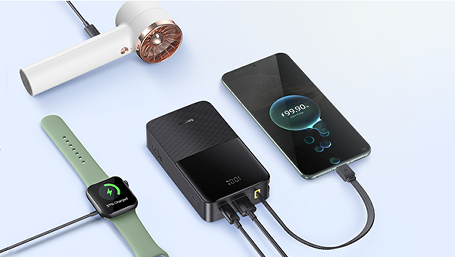 Un secador blanco, cargador portátil negro, reloj inteligente verde y teléfono cargando.