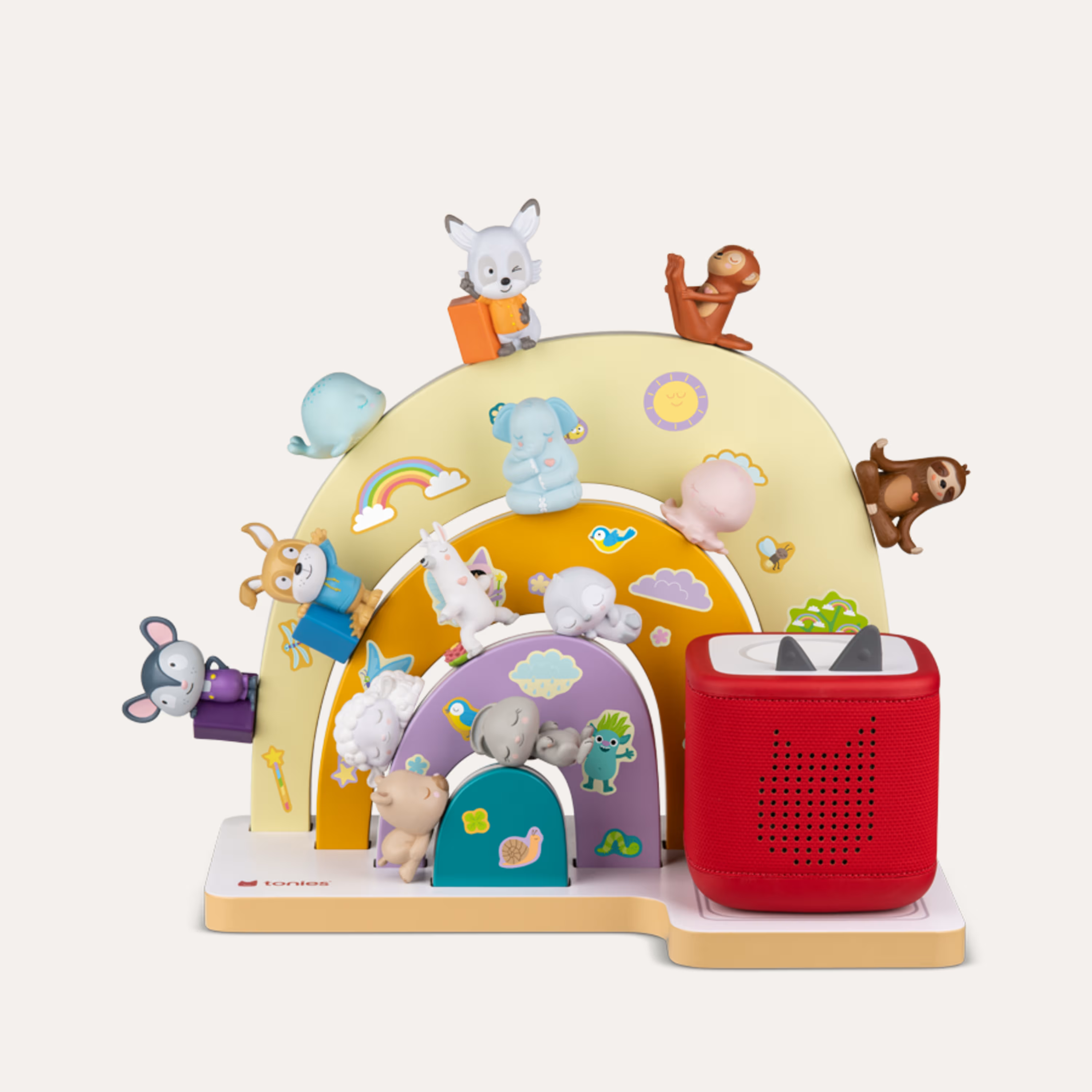 Bunte Toniebox mit Tierfiguren auf einer Regenbogenkulisse.