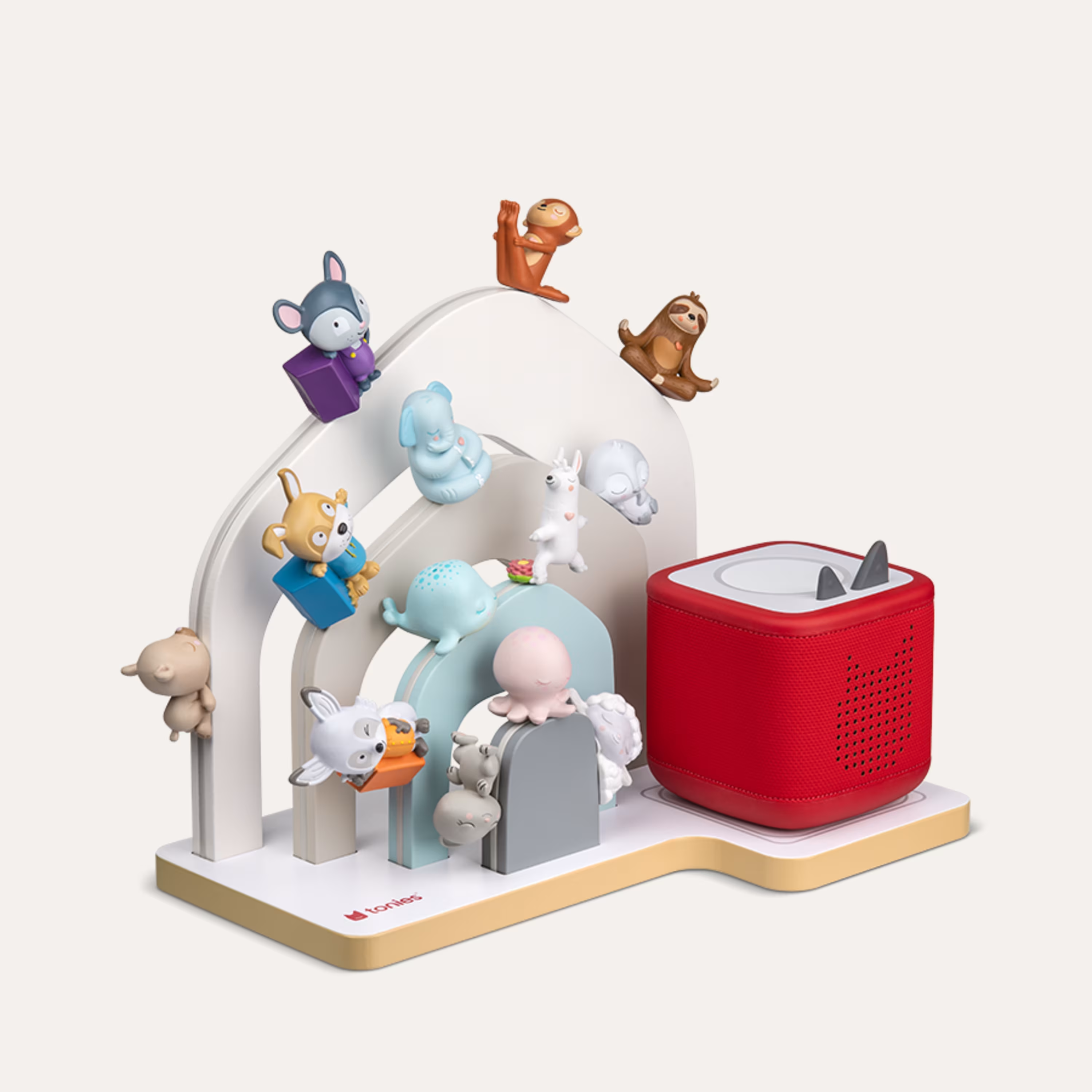 Rote Toniebox mit Tierfiguren auf einer bunten Bühne.