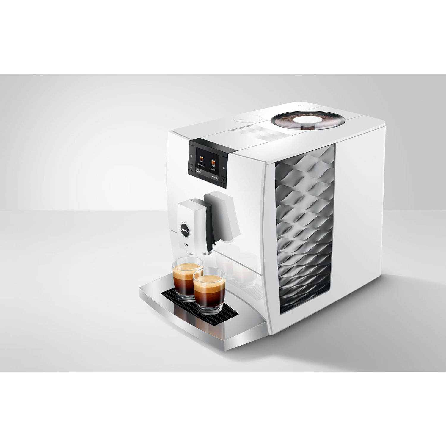Een witte koffiemachine met twee espresso glazen op de voorgrond.