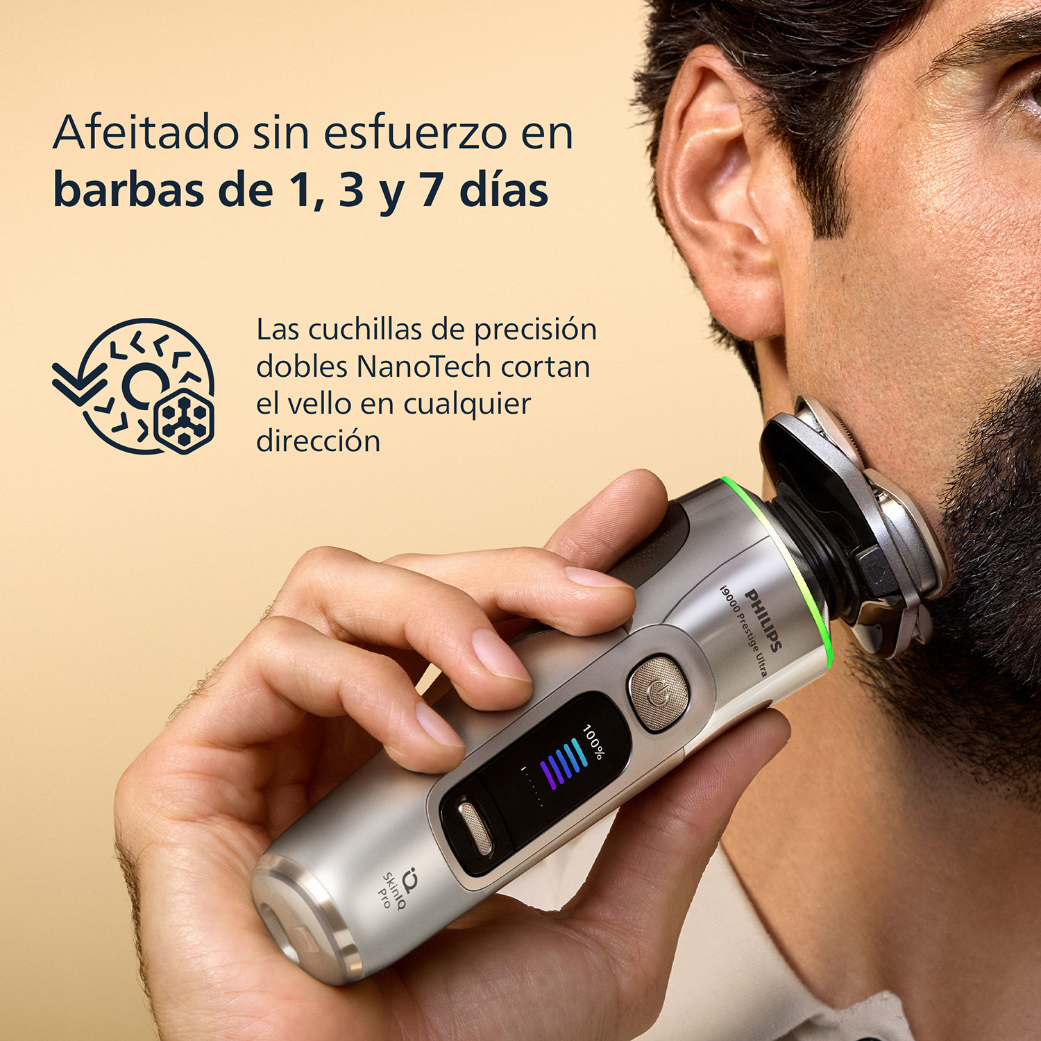 Hombre se afeita con afeitadora Philips. La afeitadora es plateada con luz LED verde.