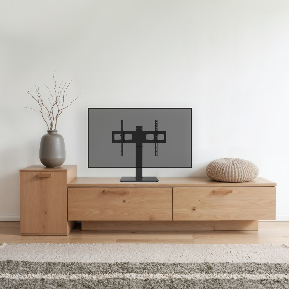 Un support TV moderne avec un écran gris sur un meuble en bois.