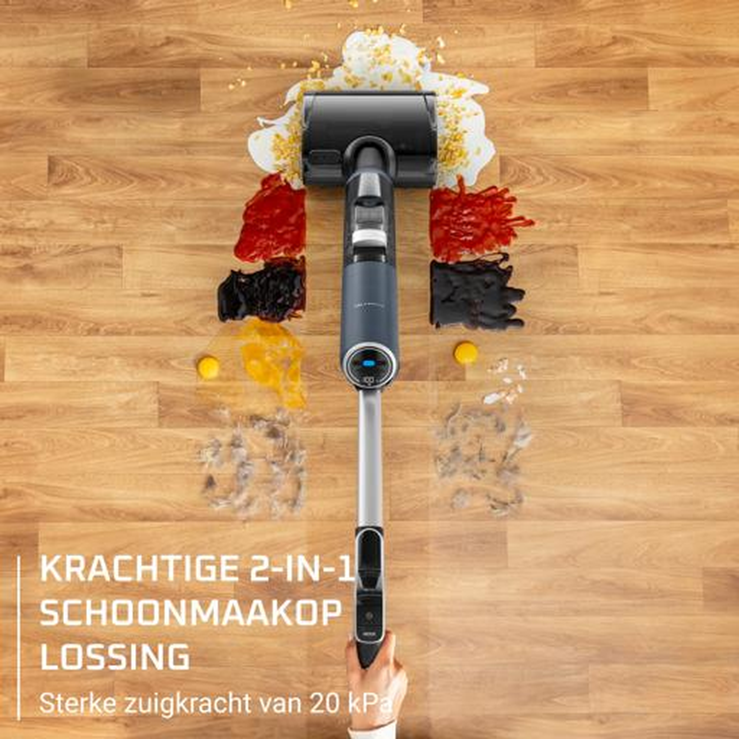 A vacuum cleaner sucks up spills and debris on a wooden floor.