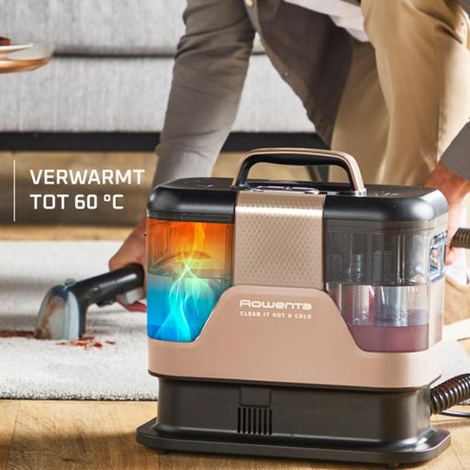 A man cleans a carpet with a Rowenta device heated up to 60°C.