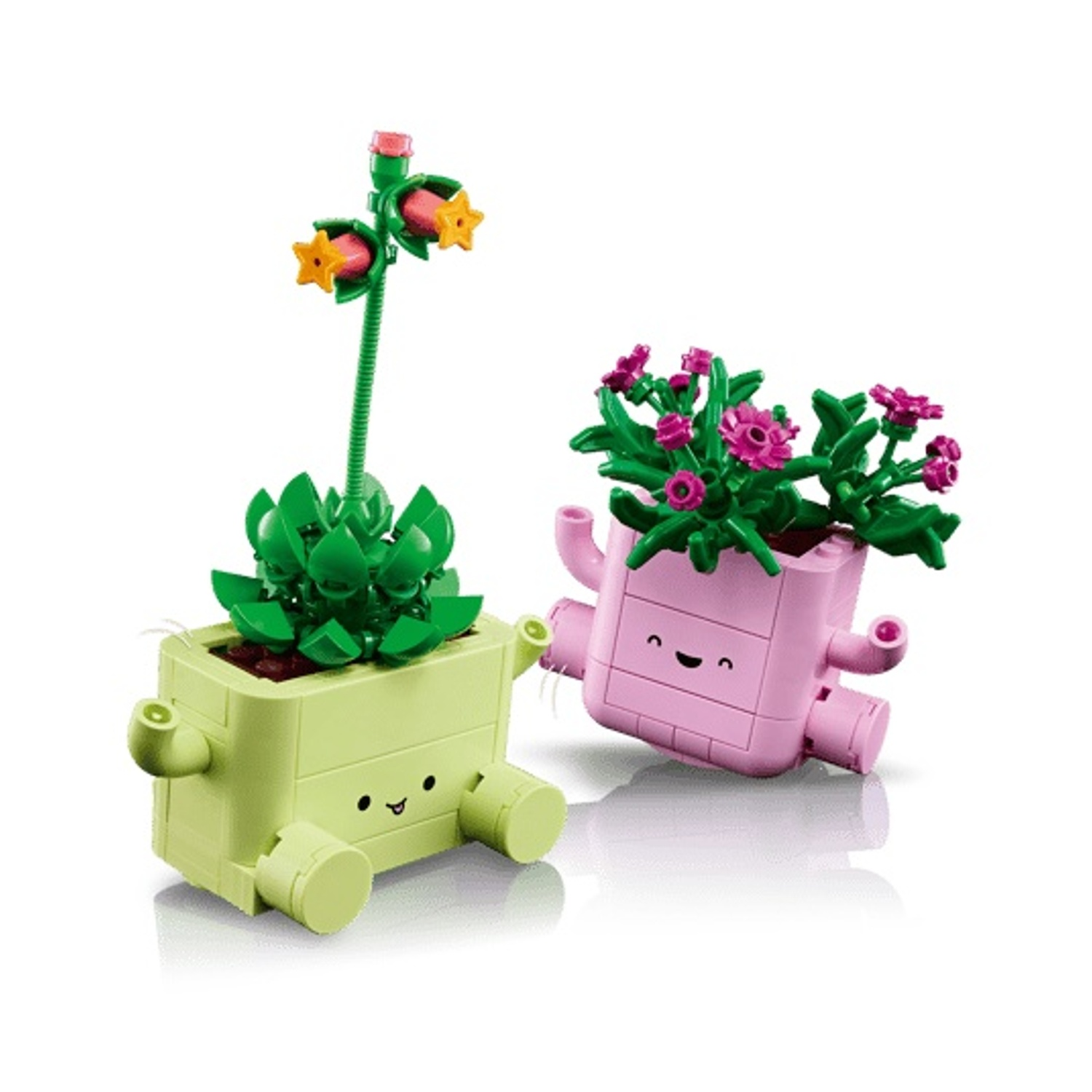 Due vasi LEGO con facce e piante. Uno è verde chiaro, l'altro rosa.