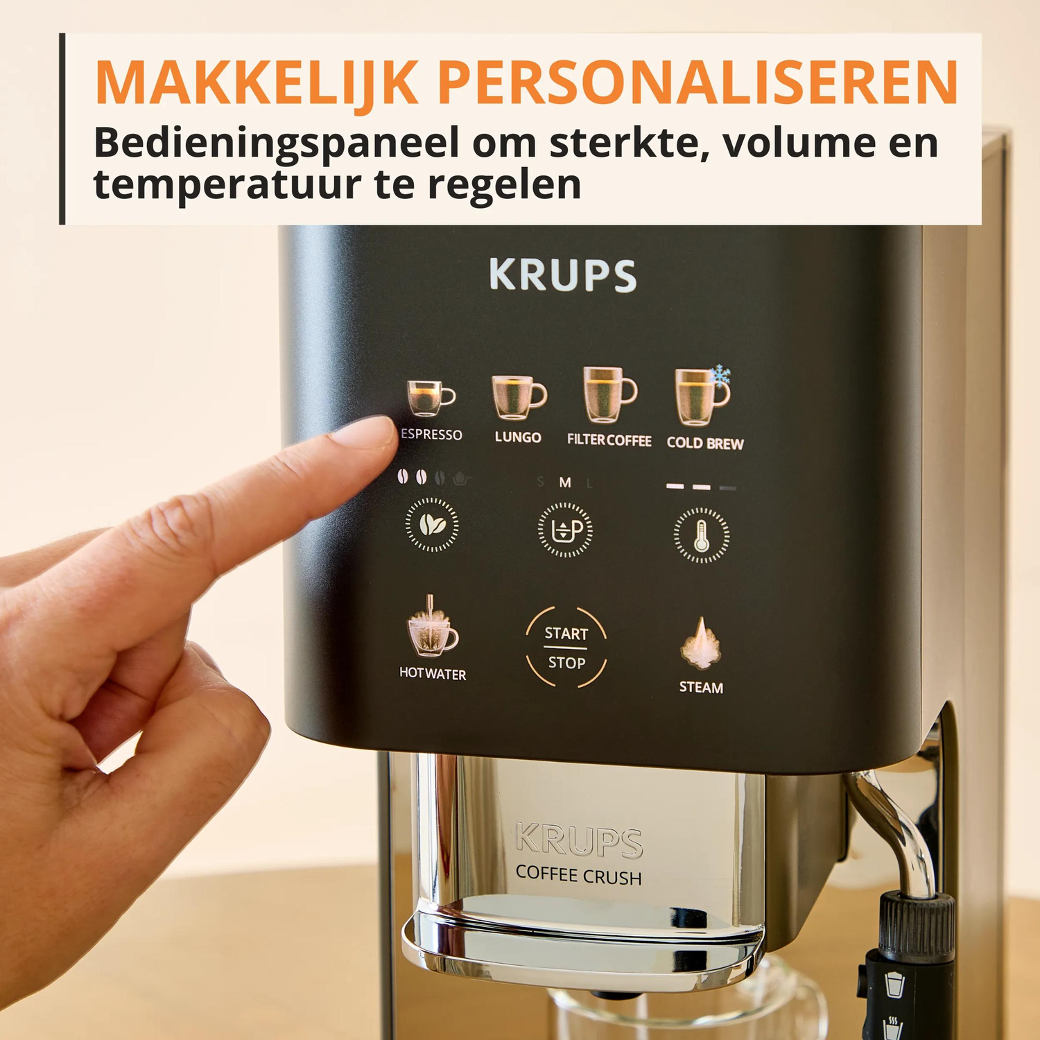 A finger touches the espresso button on a Krups coffee machine control panel.