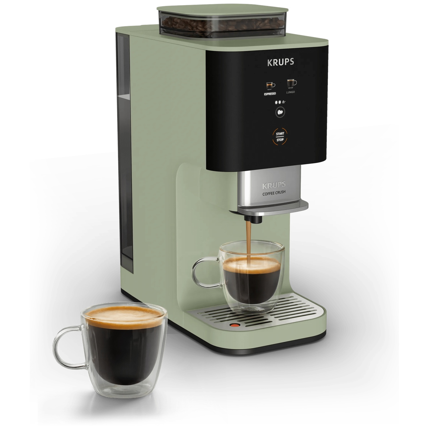 A green Krups coffee machine brews espresso into a glass. A second espresso sits beside it.