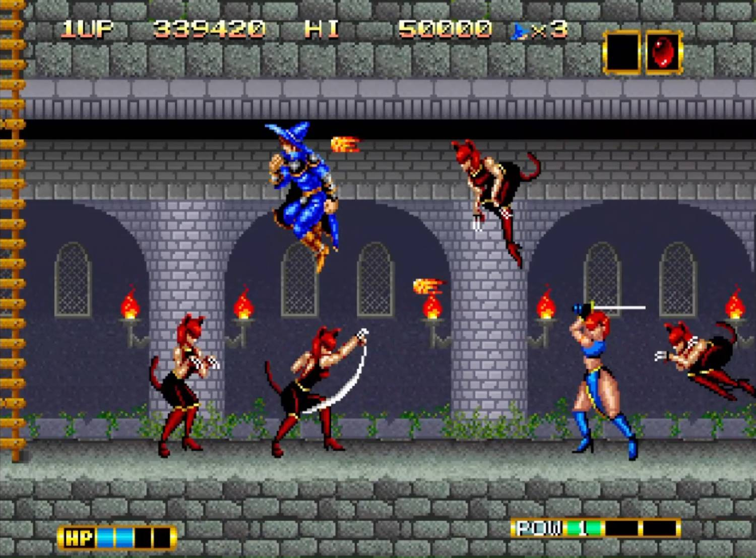 Un mago azul lucha contra chicas demonio rojas en un castillo.