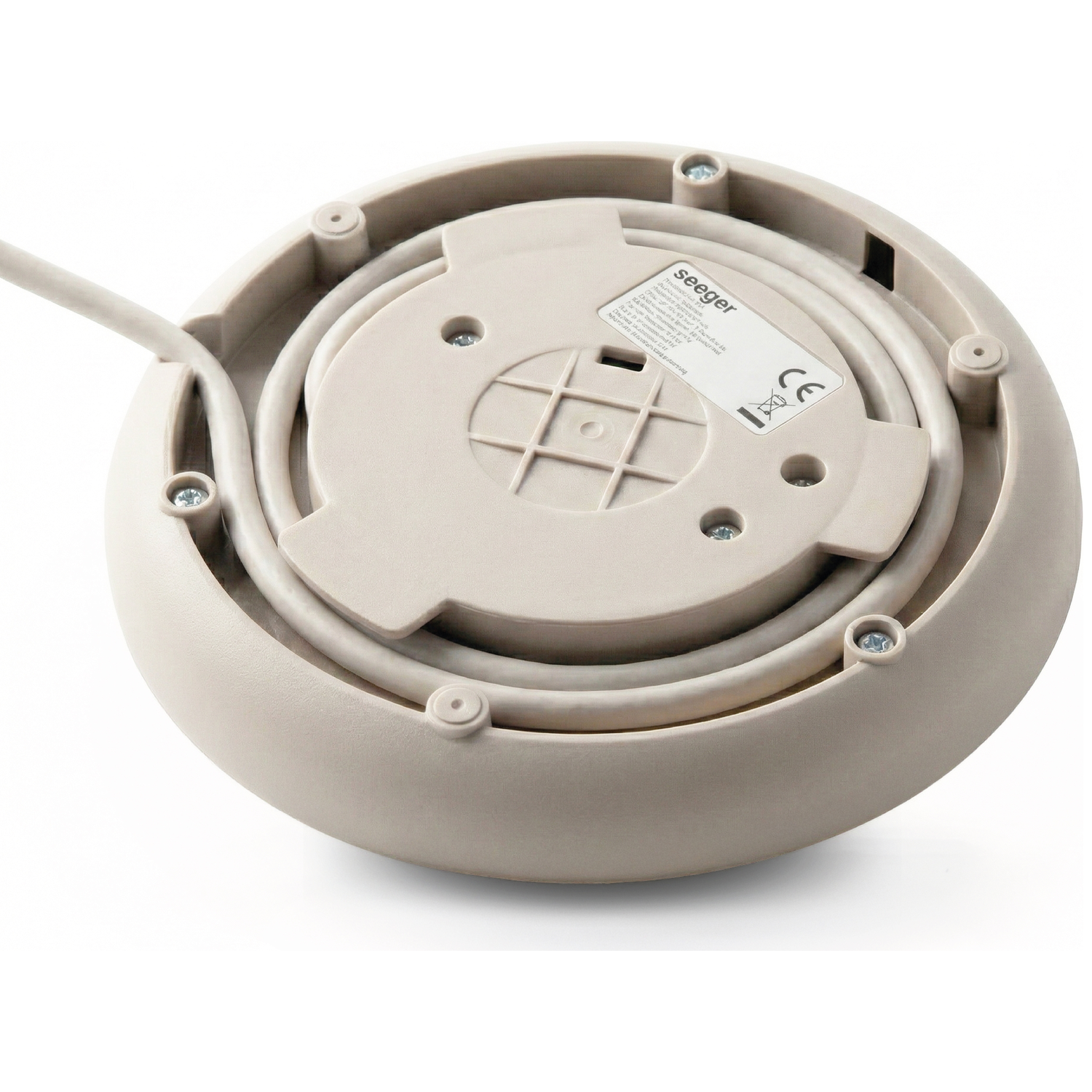 The underside of a beige appliance with a cord and label.