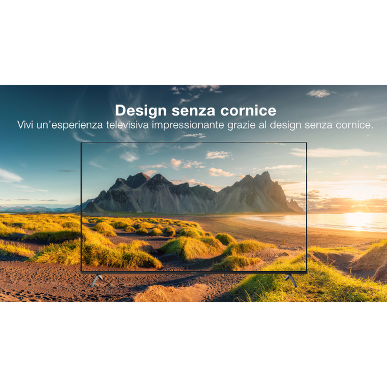 Una TV con design senza cornice mostra un paesaggio montano al tramonto.