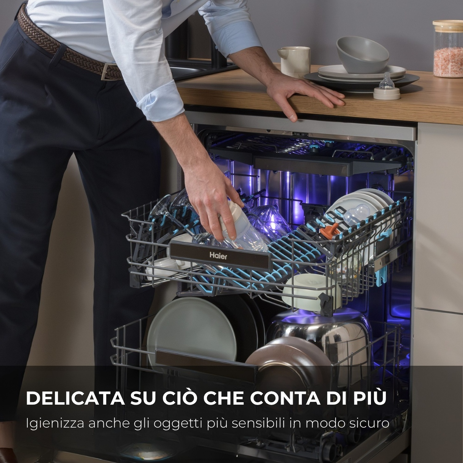 Uomo carica lavastoviglie con piatti, biberon e ciotola.