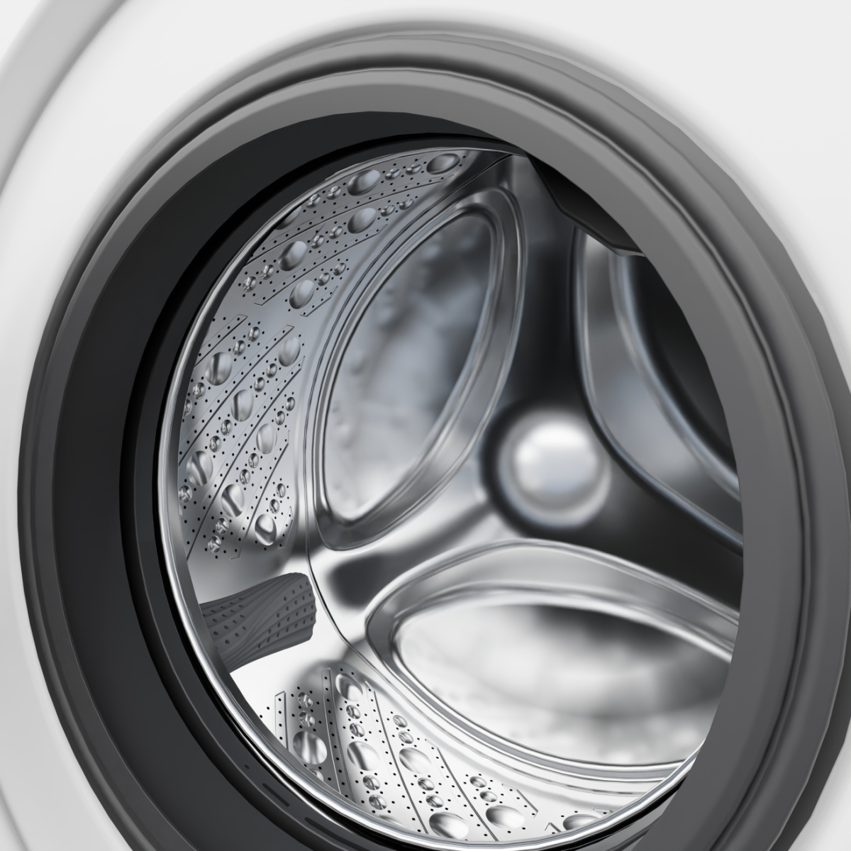 Nahaufnahme der Trommel einer Waschmaschine mit glänzenden Metalloberflächen und kleinen Löchern.