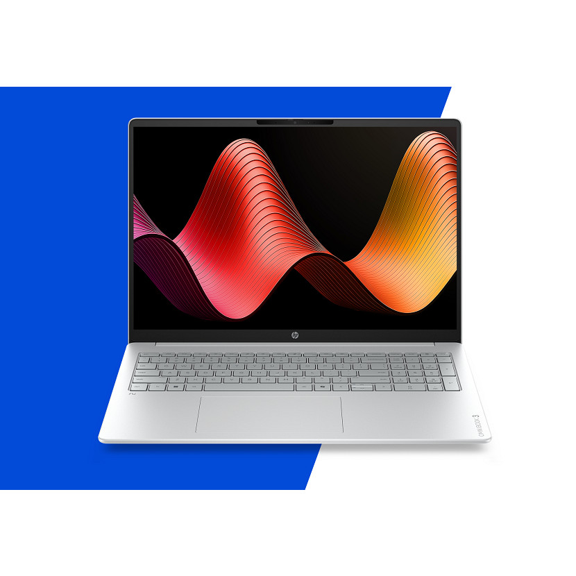 Otwarty srebrny laptop z kolorowym wzorem fal na ekranie, na tle niebiesko-białym.