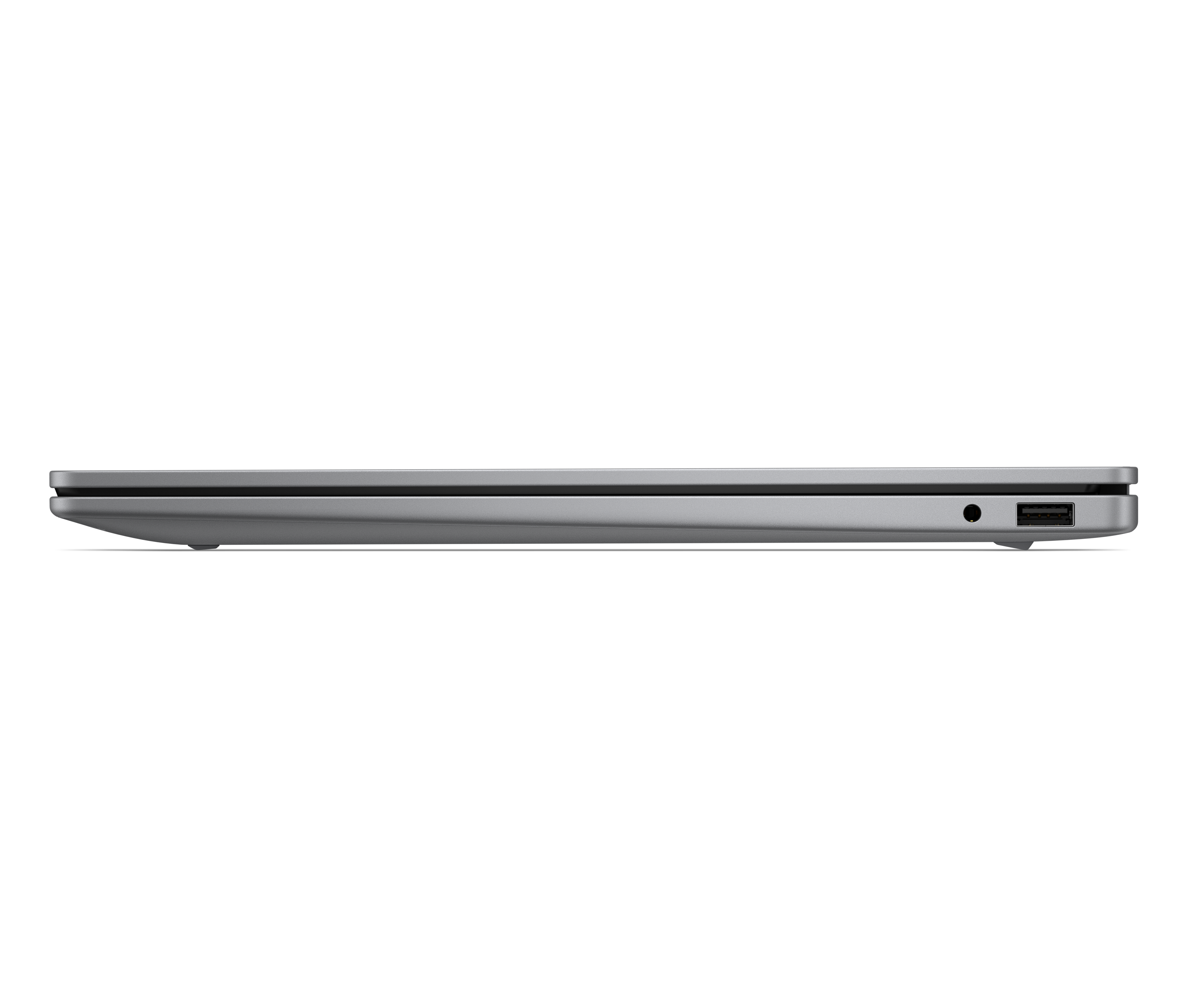 Widok z boku srebrnego laptopa pokazujący port USB i gniazdo słuchawkowe.